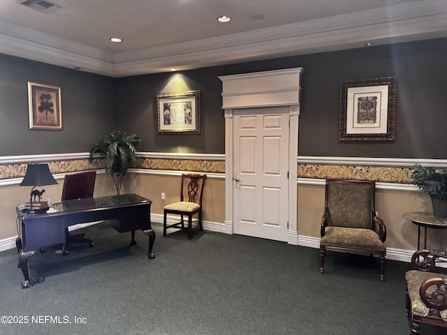 sitting room with ornamental molding and dark colored carpet