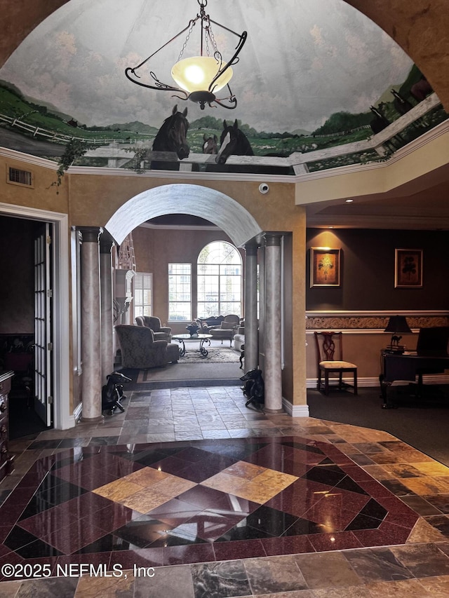 interior space featuring ornamental molding and ornate columns