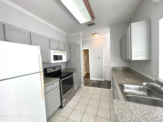 kitchen with white appliances, ornamental molding, gray cabinets, and sink