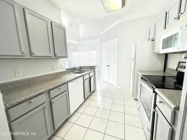 kitchen with sink, gray cabinetry, light tile patterned floors, crown molding, and white appliances