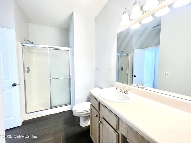 bathroom featuring vanity, toilet, an enclosed shower, and hardwood / wood-style floors