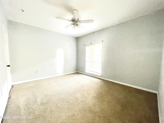 empty room featuring carpet flooring and ceiling fan