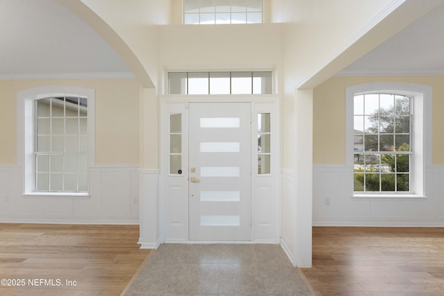 foyer entrance featuring light wood-type flooring and ornamental molding