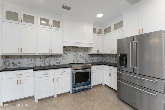 kitchen featuring tasteful backsplash, white cabinets, and stainless steel appliances