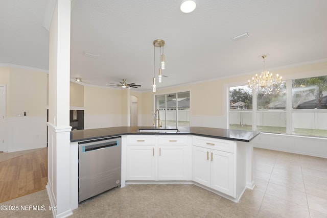 kitchen featuring stainless steel dishwasher, pendant lighting, white cabinetry, and sink