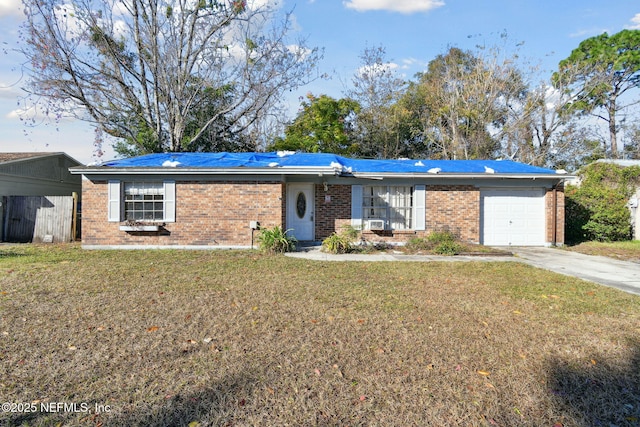 single story home featuring a front lawn, a carport, and a garage