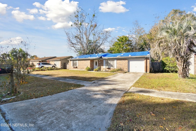 ranch-style house featuring a front yard and a garage