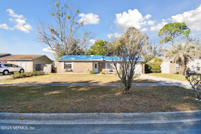 ranch-style house with a front yard and a carport