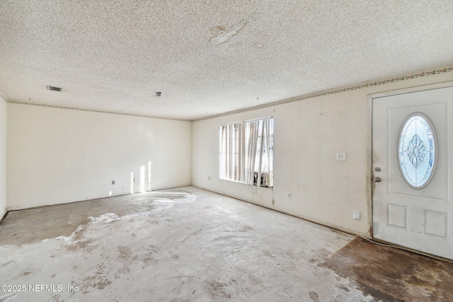 foyer with a textured ceiling