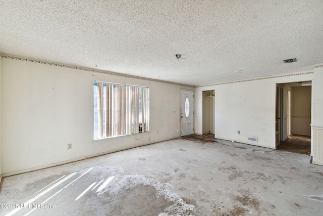 unfurnished room featuring a textured ceiling