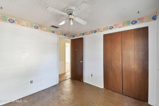 unfurnished bedroom featuring ceiling fan, a closet, and a textured ceiling