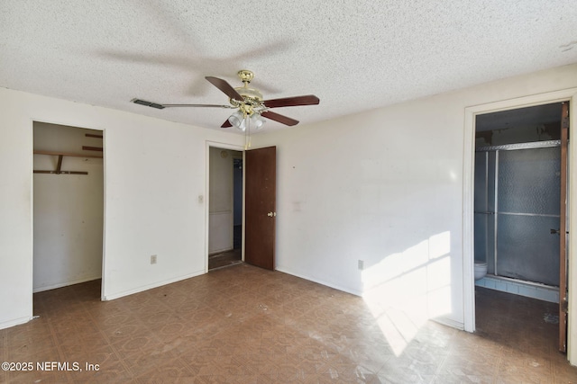 unfurnished bedroom featuring ceiling fan and a textured ceiling