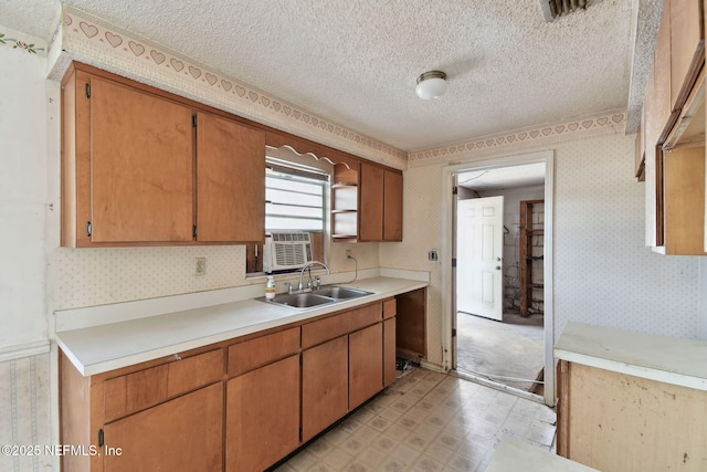 kitchen featuring a textured ceiling, cooling unit, and sink