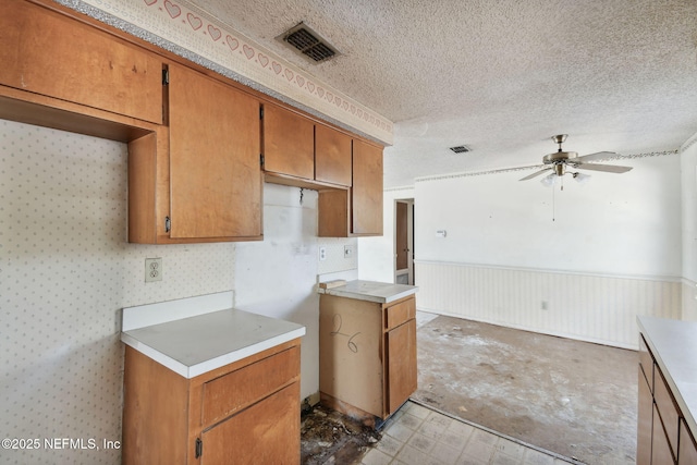 kitchen with ceiling fan and a textured ceiling