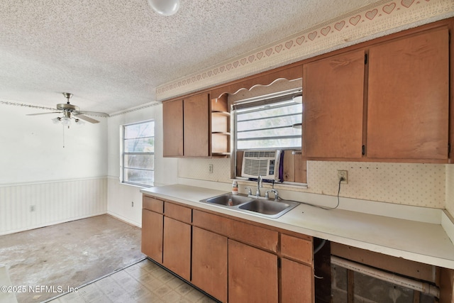 kitchen featuring a textured ceiling, ceiling fan, a healthy amount of sunlight, and sink