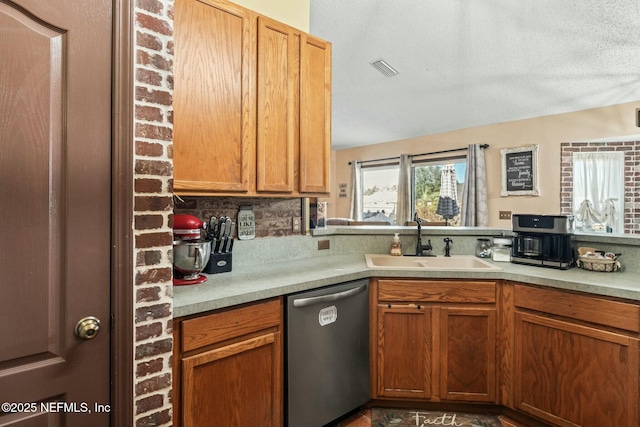 kitchen with kitchen peninsula, backsplash, a textured ceiling, stainless steel dishwasher, and sink