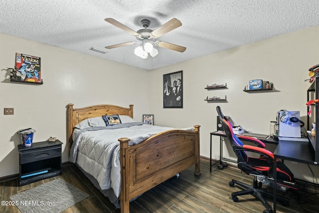 bedroom featuring ceiling fan, dark hardwood / wood-style floors, and a textured ceiling