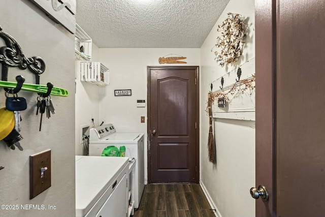 laundry area with washer and dryer and a textured ceiling