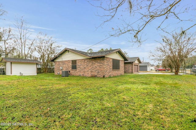 view of home's exterior with a yard, cooling unit, and a garage