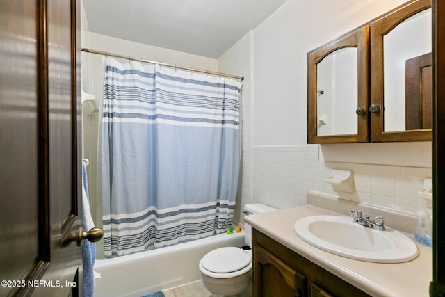 full bathroom with toilet, vanity, tile walls, and shower / bath combination with curtain