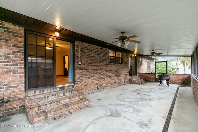 unfurnished sunroom featuring ceiling fan