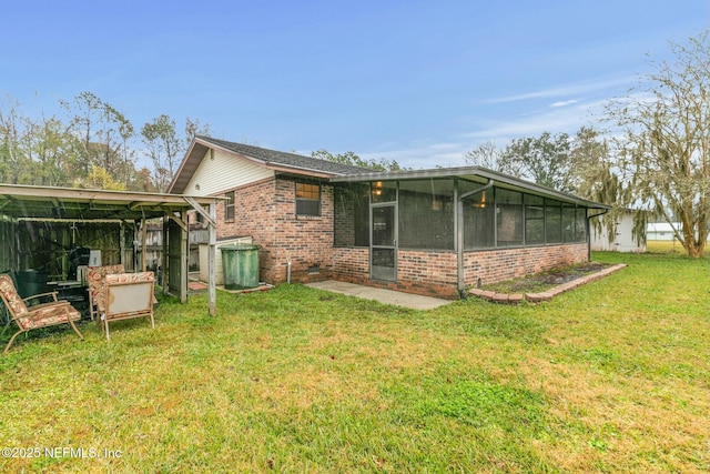 rear view of property with a yard and a sunroom