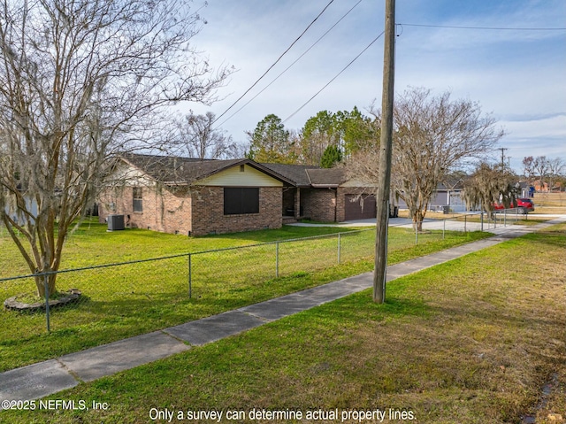 ranch-style house featuring a front yard and central AC unit