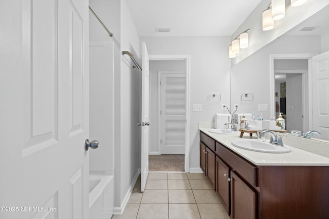 bathroom with vanity, tile patterned floors, and a bathtub