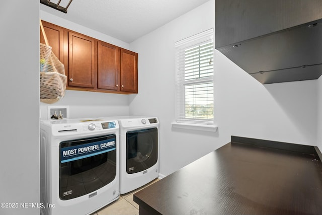 laundry area with cabinets, light tile patterned floors, and separate washer and dryer