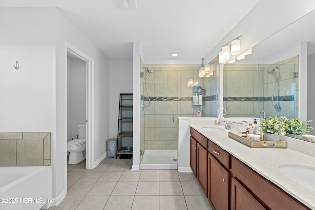 full bathroom with tile patterned flooring, vanity, separate shower and tub, and toilet