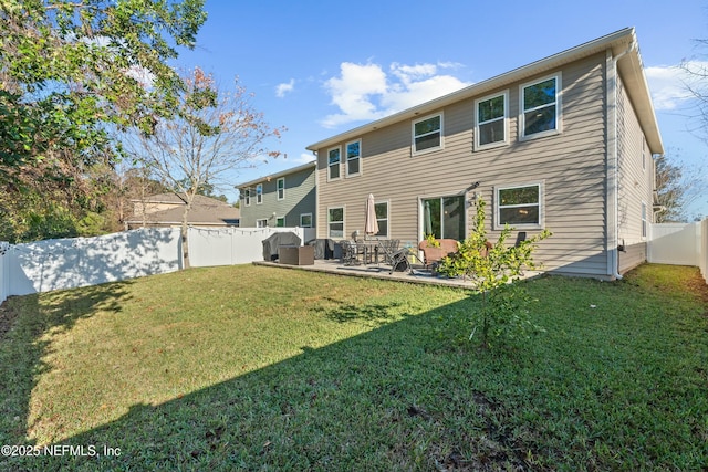 rear view of house with a patio area and a yard