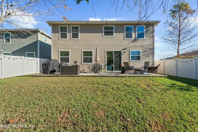 rear view of property featuring a yard and a patio