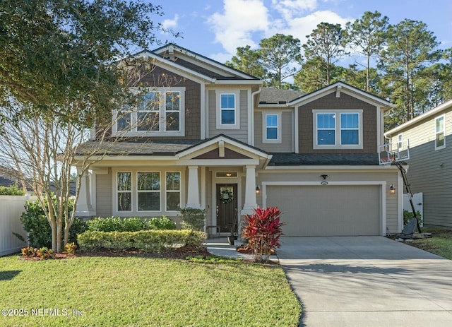 craftsman house featuring a garage and a front lawn