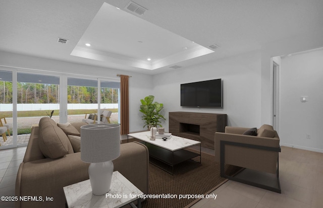 tiled living room with a premium fireplace and a tray ceiling