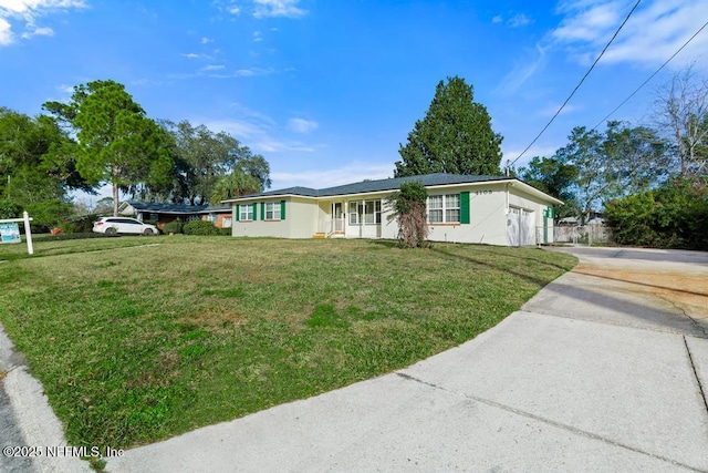 view of front facade with a front yard and a garage