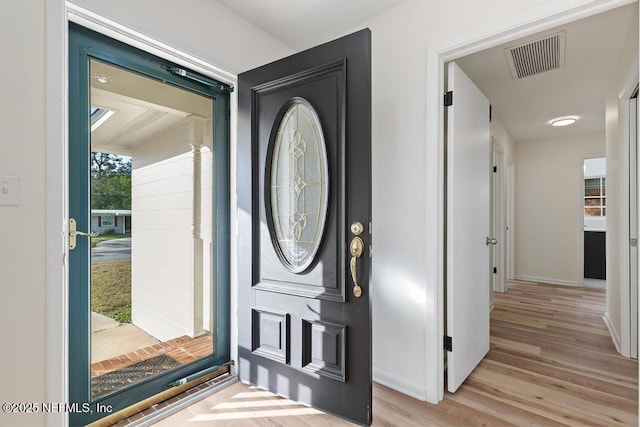 foyer entrance with light hardwood / wood-style flooring