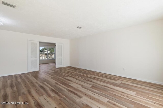 spare room with light hardwood / wood-style flooring