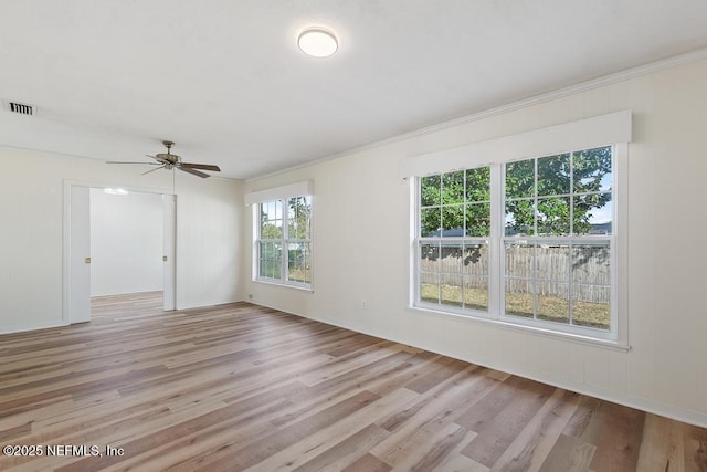 spare room featuring light hardwood / wood-style flooring, ceiling fan, and crown molding