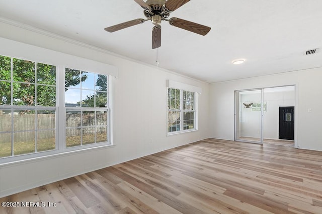 unfurnished room with ceiling fan, crown molding, and light hardwood / wood-style floors