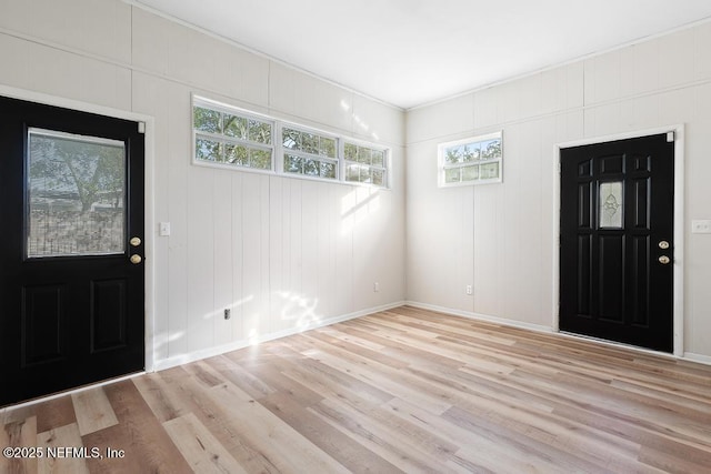 foyer entrance featuring light hardwood / wood-style floors and ornamental molding