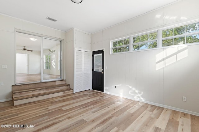 spare room featuring ceiling fan and light hardwood / wood-style flooring