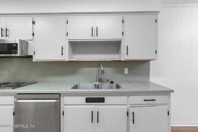 kitchen featuring backsplash, white cabinetry, sink, and appliances with stainless steel finishes