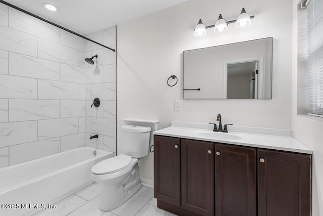 full bathroom featuring vanity, tiled shower / bath combo, and toilet