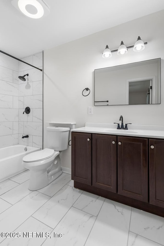 full bathroom with vanity, tiled shower / bath combo, and toilet