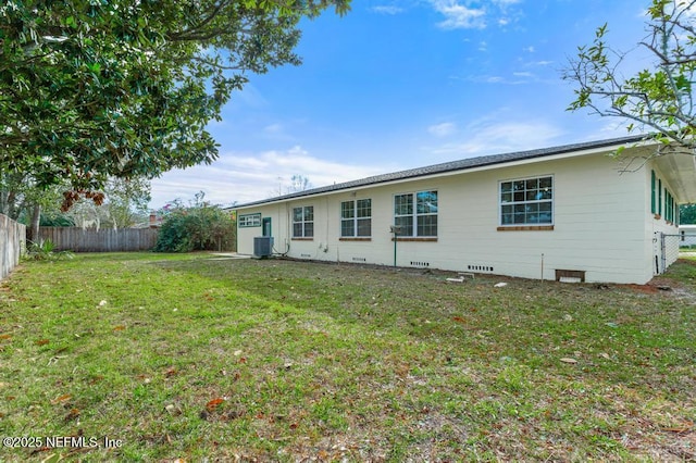 back of property with a yard and cooling unit