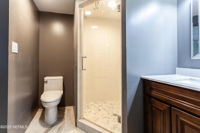 bathroom featuring toilet, vanity, and walk in shower