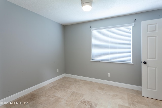 spare room with a textured ceiling