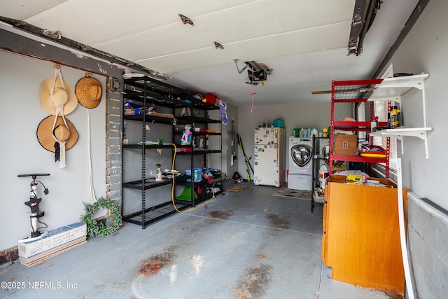 garage featuring washer and dryer, white refrigerator, and a garage door opener