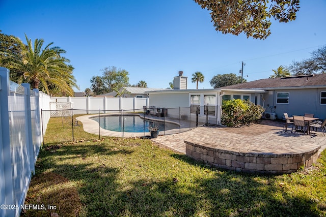 view of pool with a lawn and a patio area