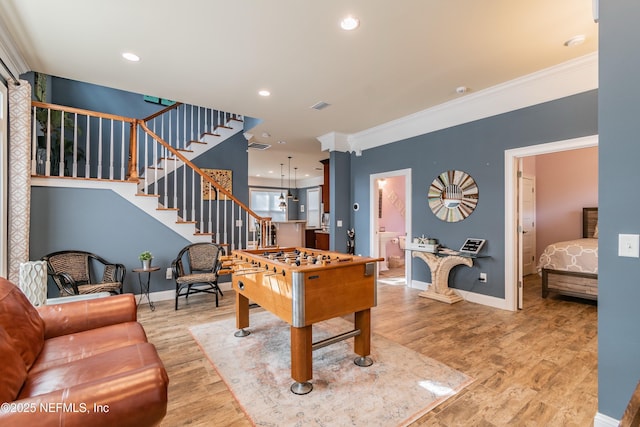 playroom featuring ornamental molding and hardwood / wood-style flooring